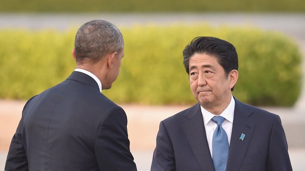 U.S. President Barack Obama (L) shakes hands with Japanese Prime Minister Shinzo Abe during his visit to the Hiroshima Peace Memorial Park on May 27, 2016