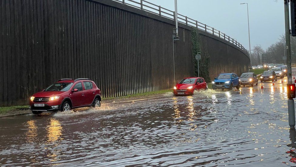 Cars driving through flood water in Pontypridd
