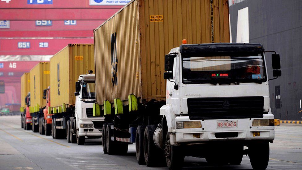 Trucks transport containers at a port in Qingdao, China