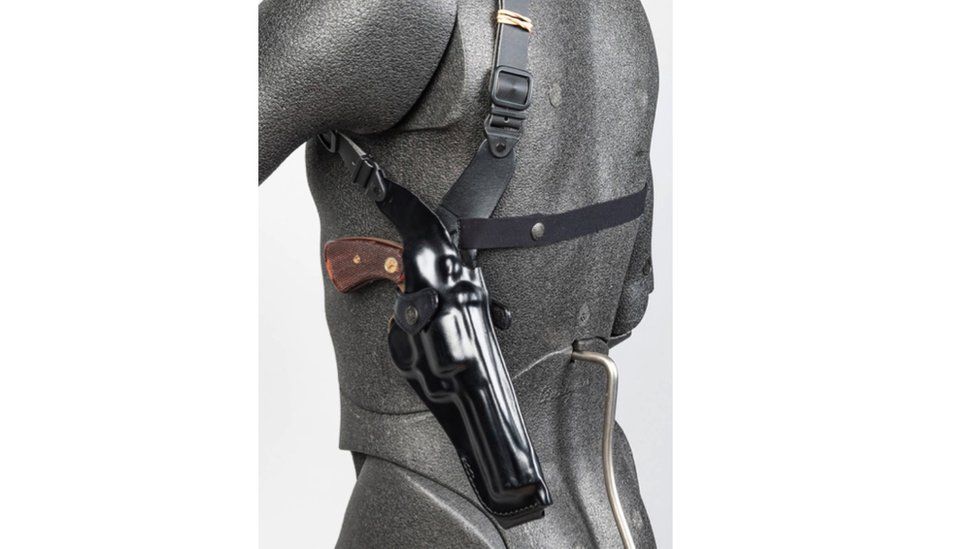 A computer-generated image of a torso with a holster under the left armpit with a revolver in it