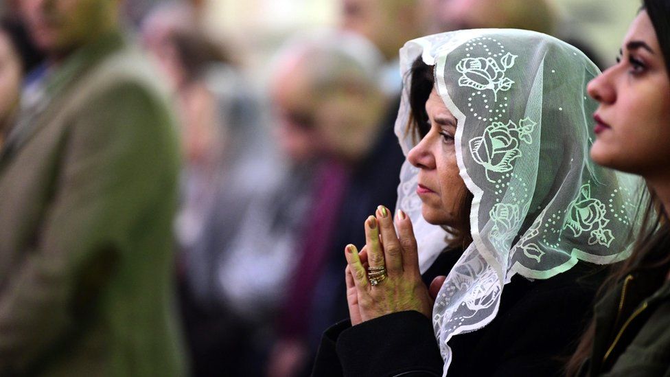 Iraqi Christians attend a Christmas Mass at St. George Anglican church in Baghdad