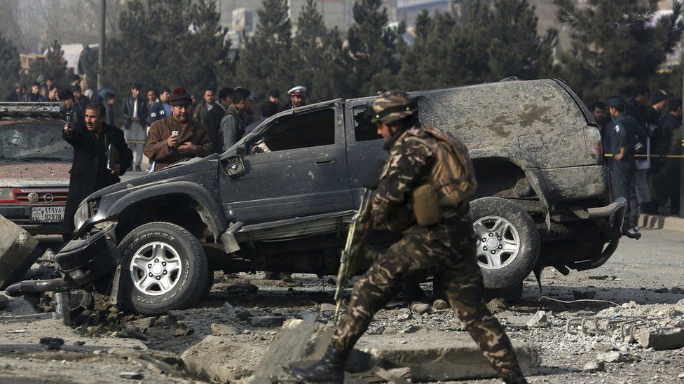 In this 28 December 2016 image Afghan security personnel inspect the site of roadside bomb blast in Kabul, Afghanistan