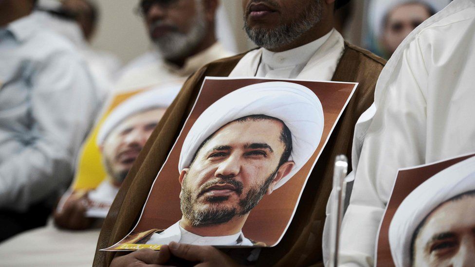 Bahraini man holding a placard bearing the portrait of Sheikh Ali Salman (29 May 2016)