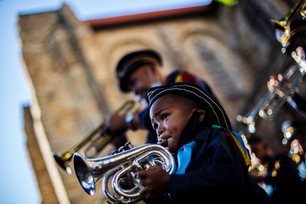 Alex Williams, four, plays with Church Lads and Girls Brigade outside the St Georges Cathedral in Cape Town, South Africa - Friday 31 December 2021