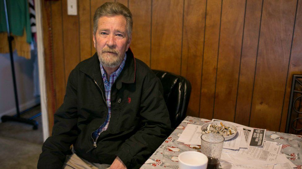 Leslie McCrae Dowless sitting in his home