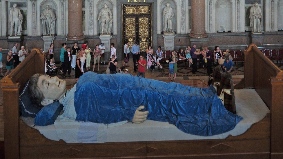 Members of the public view the Grandmother Giant sleeping in St George's Hall