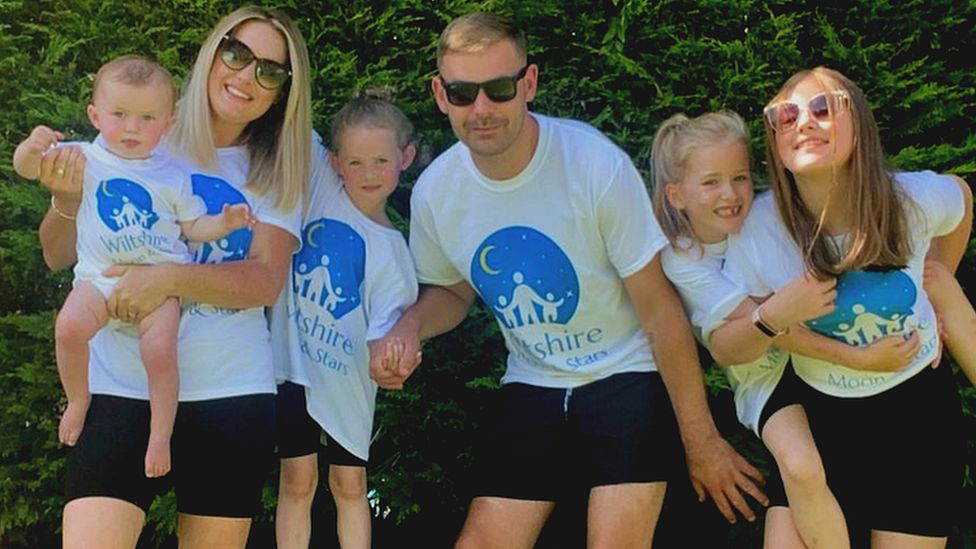 Abbyy Lever and Jamie Davey with their children whilst in the garden.