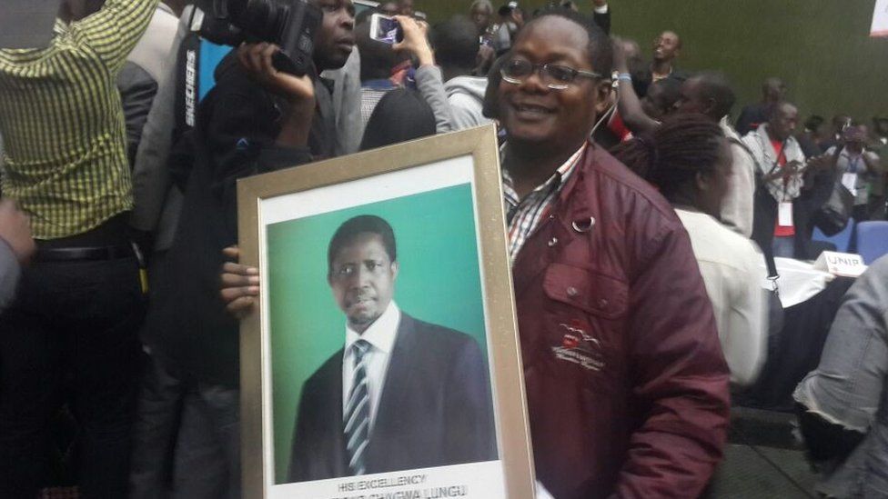 supporter hold a portrait of Edgar Lungu at electoral commission