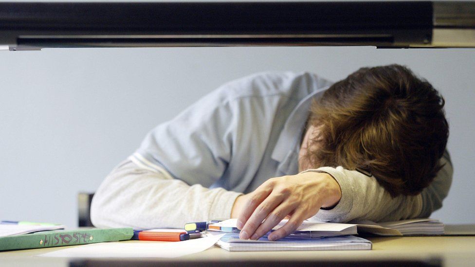student sleeping on a desk