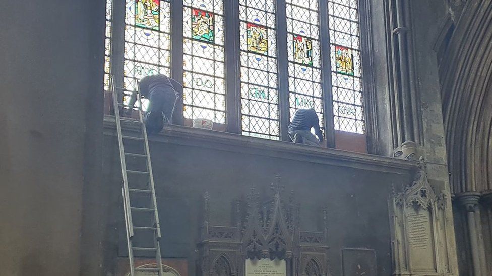 Workers covering up the Colston name