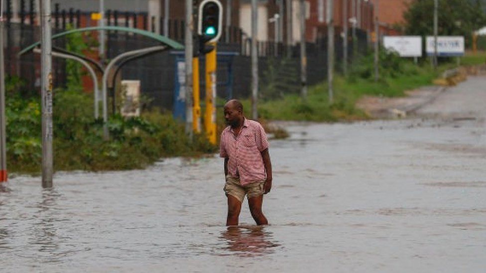 Man walking through a flooded road
