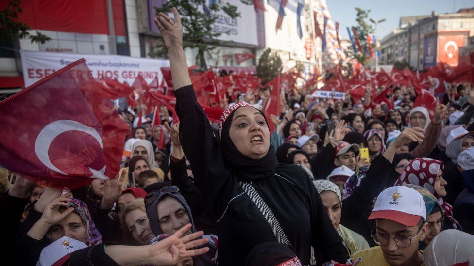 Supporters chant slogans and wave flags as they listen to President Recep Tayyip Erdogan of Turkey address the crowd during a campaign rally on May 26, 2023 in Istanbul