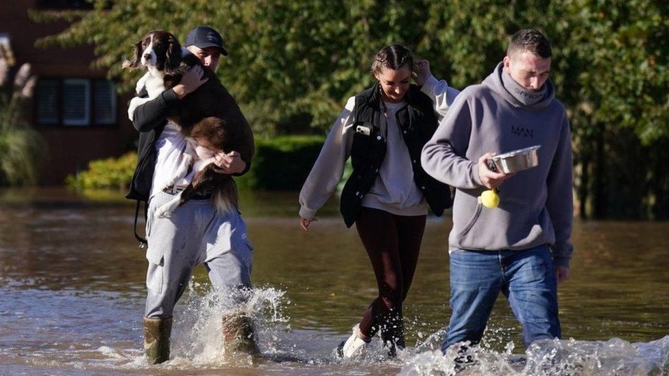 Residents walk through flood water in Retford in Nottinghamshire