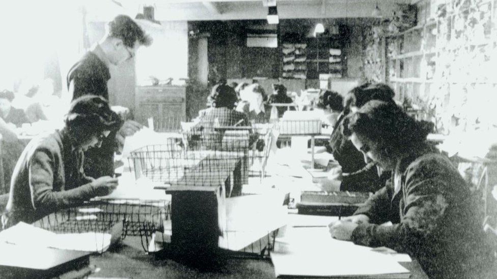 Women in military uniform at a table in Hut 3 Bletchley Park, Buckinghamshire code-breaking.