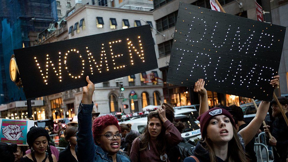 A group of protesters rally against Donald Trump outside of Trump Tower in New York City.