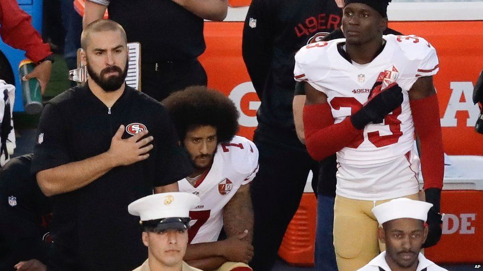 San Francisco 49ers quarterback Colin Kaepernick kneels during the national anthem before the team's NFL preseason football game on 1 September