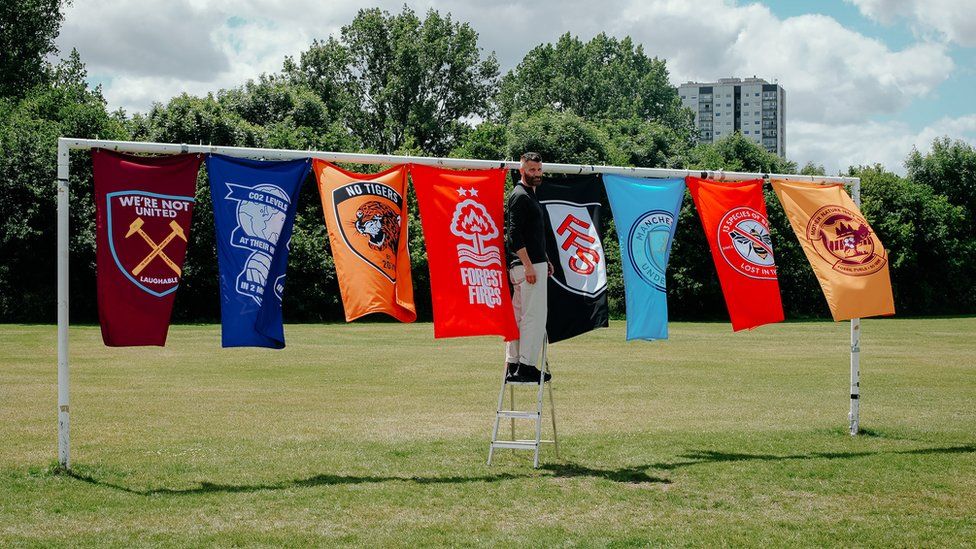 Kyle Harman-Turner with Climate Clubs flags