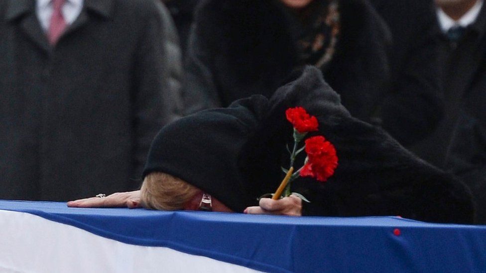Andrei Karlov's widow Marina weeps on his coffin