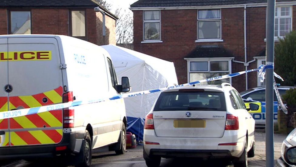 Road cordoned-off and a crime scene tent