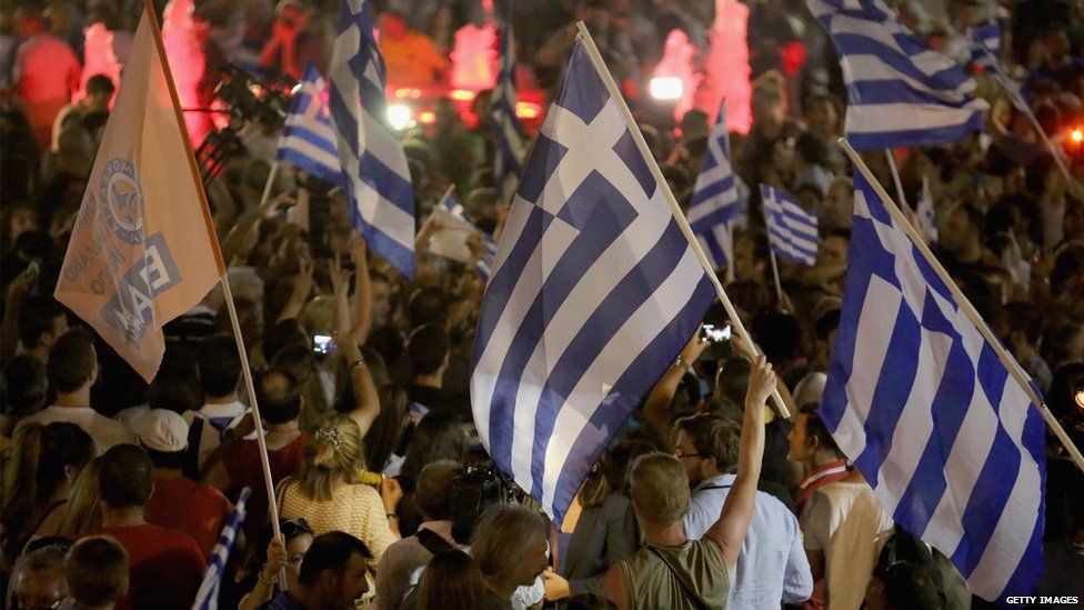 People celebrate in front of the Greek parliament as early opinion polls predict a win for the Oxi (no) campaign in the Greek austerity referendum 5 July 2015