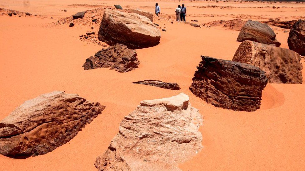 Remains of the two millenia-old site of Jabal Maragha that was ravaged by gold hunters are scattered on the sand in the desert of Bayouda,