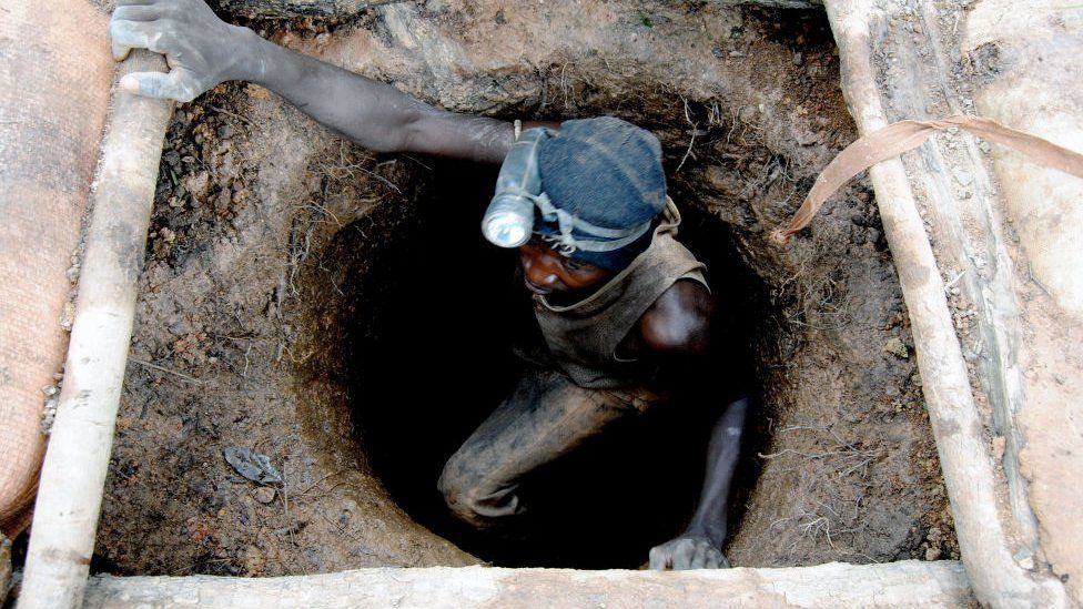 A Malian gold panner coming out of an underground mine at an artisanal gold mining site in Sadiola (north-western Mali). Gold attracts many young people from the region (Ghana, Guinee, Burkina-Faso, Senegal..) to its mining sites where gold panners use rudimentary means for its exploitation.