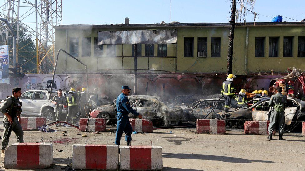 Afghan police inspect the site of a blast in Jalalabad, Afghanistan, July 1, 2018