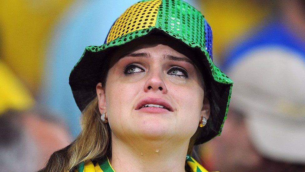 A fan cries after a Brazil defeat