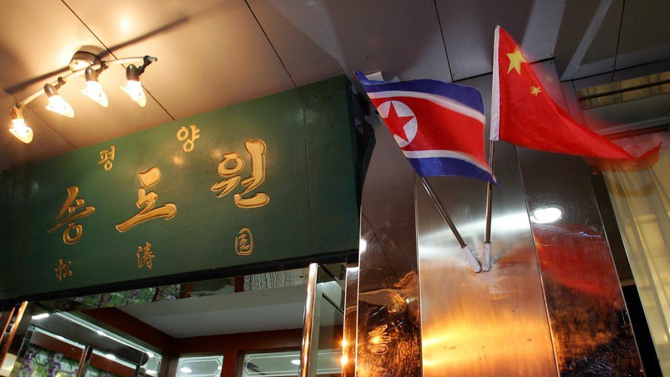 The national flags of North Korea and China are hung in front of a North Korean restaurant October 9, 2006 at the border city of Dandong, Liaoning Province of China.