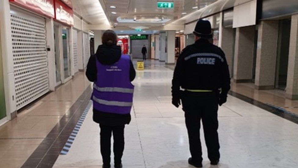 Two officers in a shopping centre