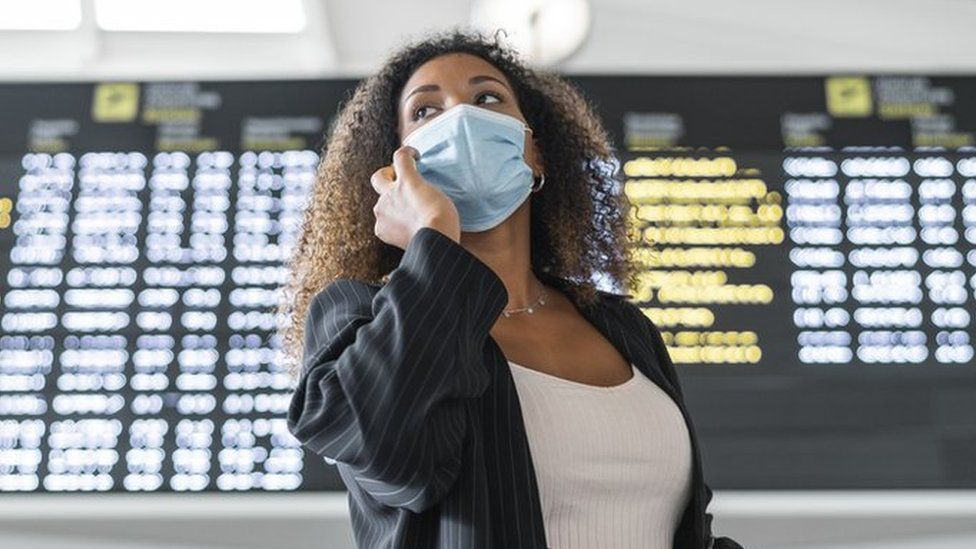 Woman wearing face mask at an airport