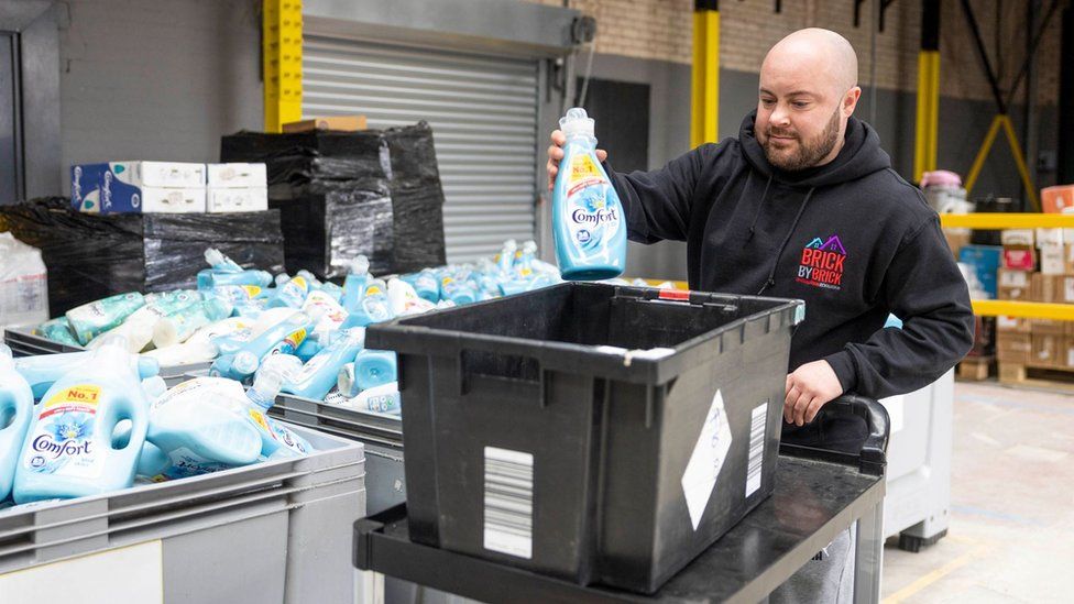 Man sorts donations into box