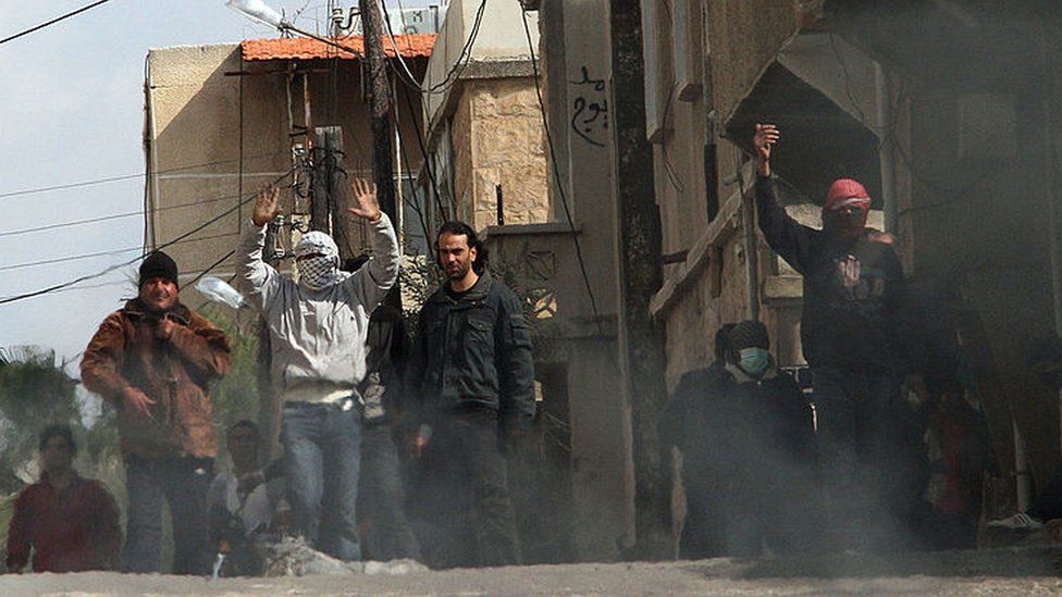 Anti-government protesters on the streets of the Syrian city of Deraa on 23 March 2011