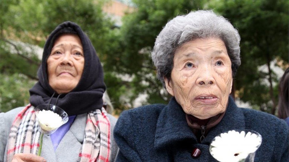 A picture made available 26 December 2015 shows former Philippine comfort woman, Estelita B. Dy (L), and former Taiwan comfort woman, Cheng Chen-tao (R), commemorating deceased comfort women outside Japan"s representative office in Taipei, Taiwan, 10 December 2012.