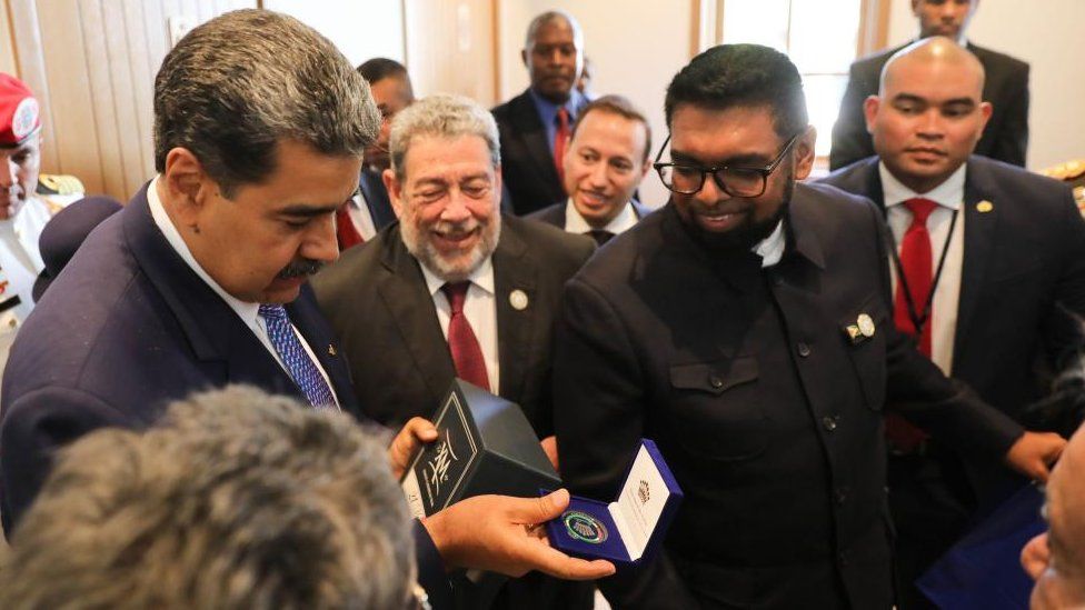 A handout photo made available by Prensa Miraflores shows the Presidents of Venezuela Nicolas Maduro (L) and of Guyana Irfaan Ali (R) in an exchange of gifts during a meeting in which they wished each other 'peace and love' within the framework of the 8th summit of the Community of Latin American and Caribbean States (CELAC) in Kingstown, Saint Vincent and the Grenadines, 01 March 2024.