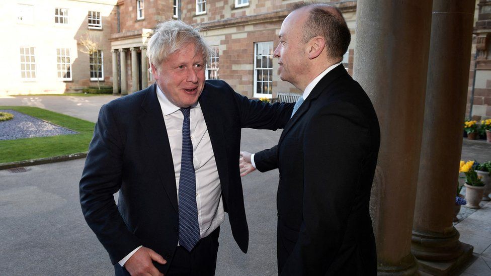 Former British Prime Minister Boris Johnson greets Northern Ireland Secretary Chris Heaton-Harris as he arrives at Hillsborough Castle for the Gala dinner to mark the 25th anniversary of the Good Friday Agreement, in Hillsborough, Northern Ireland, April 19, 2023.