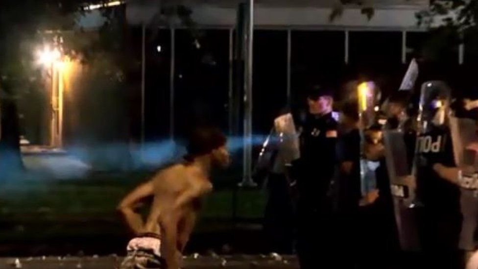 Video showed one shirtless man spitting towards officers