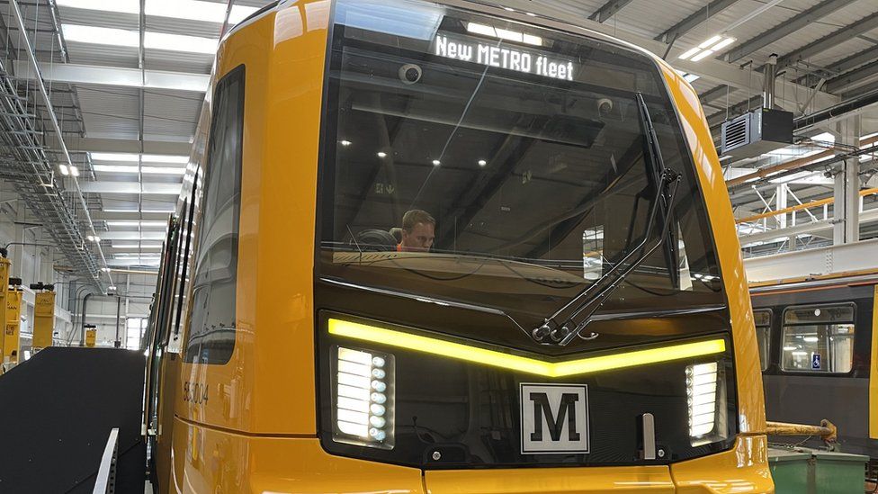The front of the new train which has a large window with a yellow frame