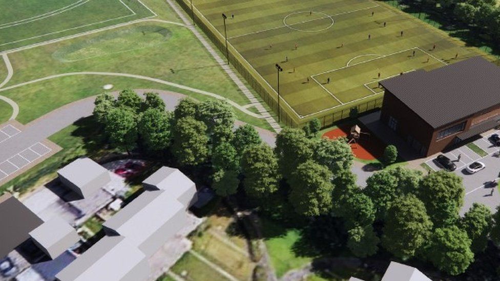 aerial view of the proposed plans - a housing estate, a building and a football pitch