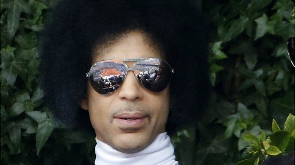 U.S. singer Prince watches a men's singles match between Rafael Nadal of Spain and Dusan Lajovic of Serbia at the French Open tennis tournament at the Roland Garros stadium in Paris in this June 2, 2014