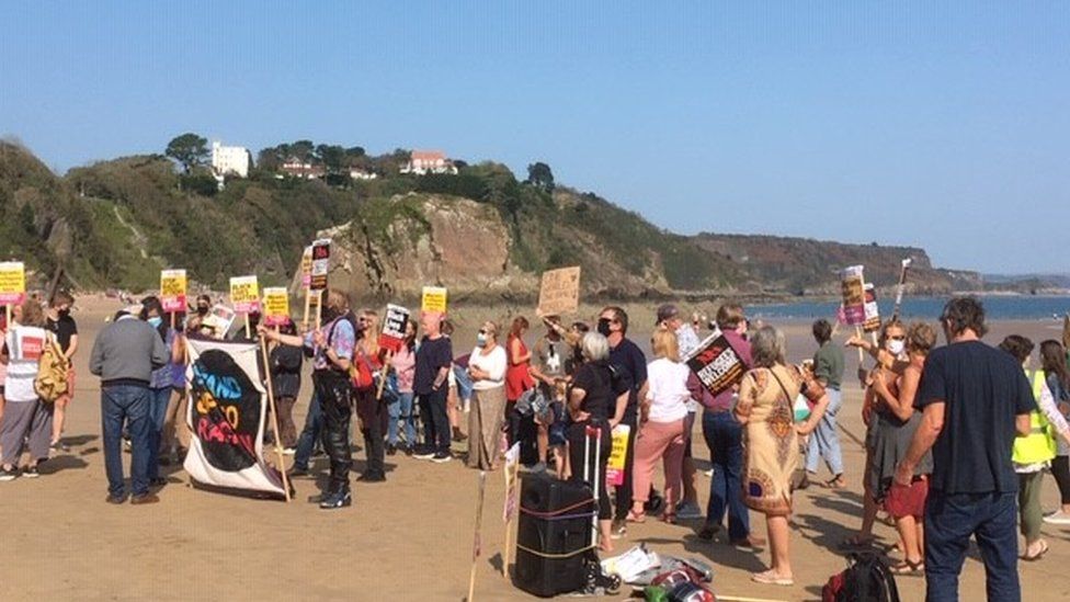 Protestors on a beach in Tenby