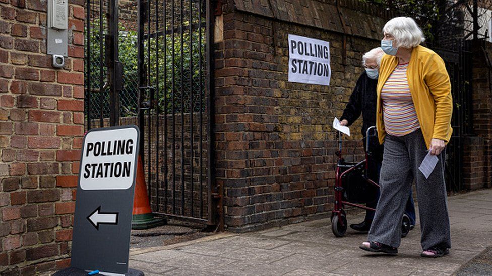 Two woman going to vote at a polling station in London, England