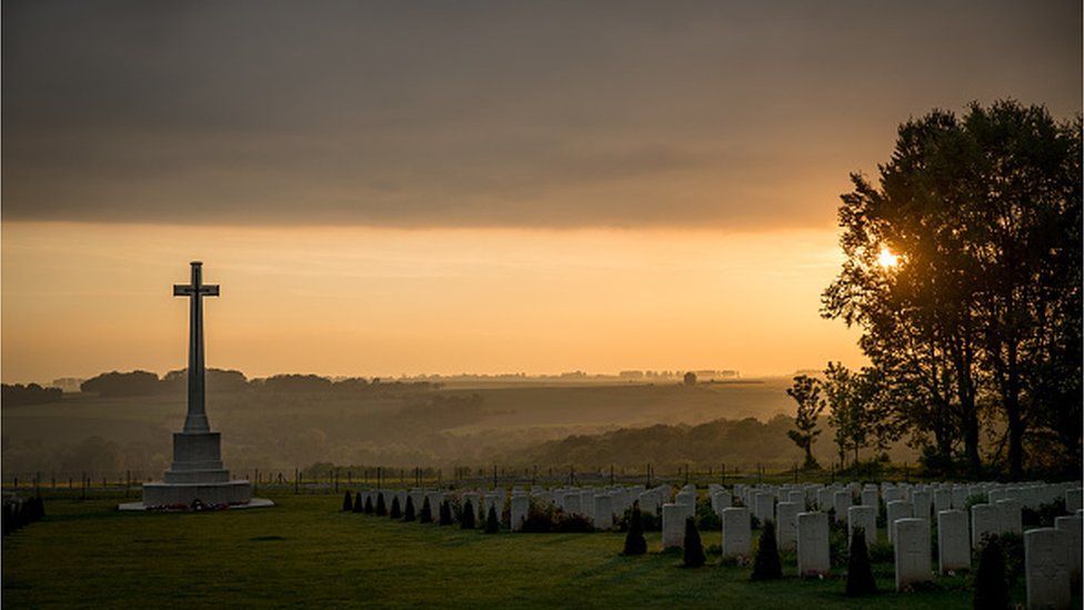 The sun sets over the joint British and French cemetery at the Thiepval Memorial