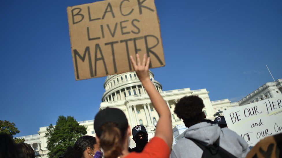 Protestors hold signs as they demonstrate in front of the United States Capitol in Washington, DC, on June 2, 2020