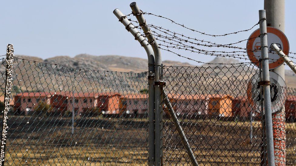 Barbed-wire encircles the Mineo migrant reception centre in Sicily, 8 July 2019