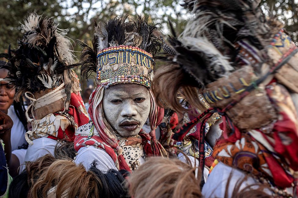 Traditional dancers perform as the remains of slain Democratic Republic of Congo independence hero Patrice Lumumba arrive in Shilatembo on 26 June 2022