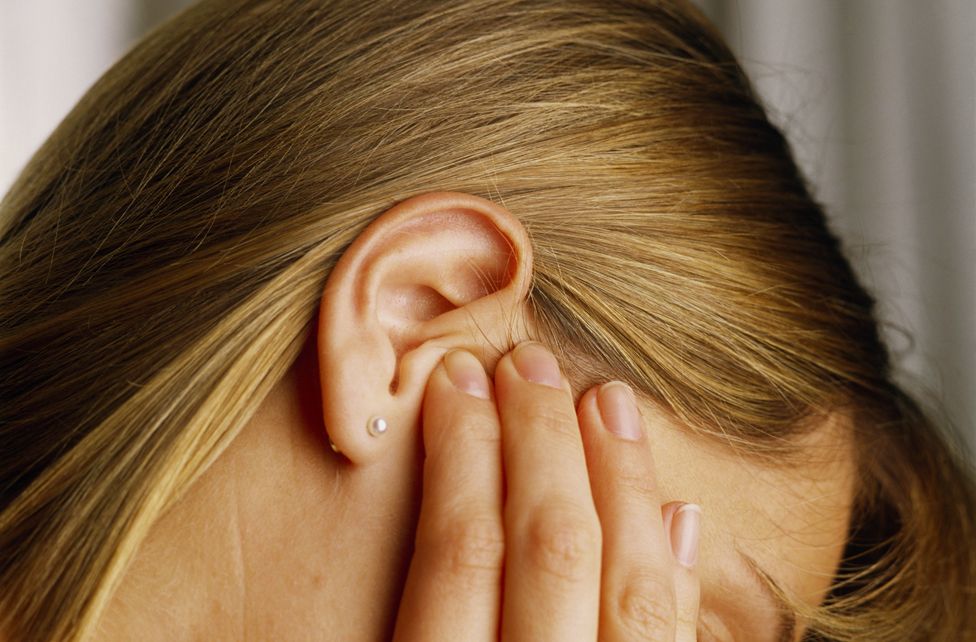 Woman with ear disorder