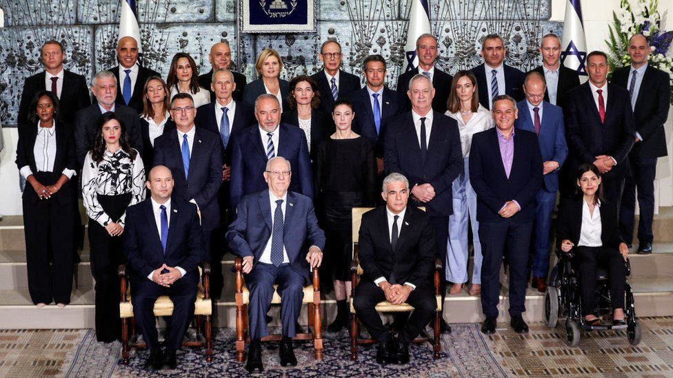 Israel"s President Reuven Rivlin (front row, centre) sits next to Prime Minister Naftali Bennett and ministers of the new Israeli government in Jerusalem (14 June 2021)