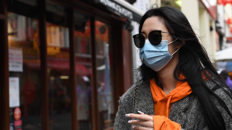 A woman wears a face mask in Chinatown in London, Britain, 04 February 2020. London"s Chinatown is feeling the impact of the Coronavirus as restaurants are seeing a down in customers following the confirmation of new coronavirus cases in the UK.