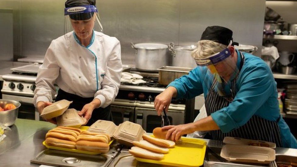 Kitchen staff prepare school lunches for pupils
